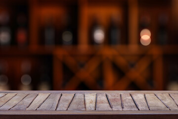 Empty wooden table and blurred wine drink counter background..