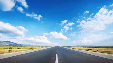 Fototapeta premium asphalt road with white lines, sunny view, blue sky with clouds above,