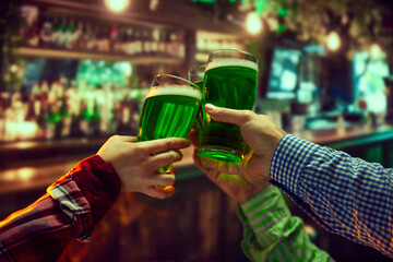 Group of friends meeting in local pub, drinking beer, clinking glasses over bar background....