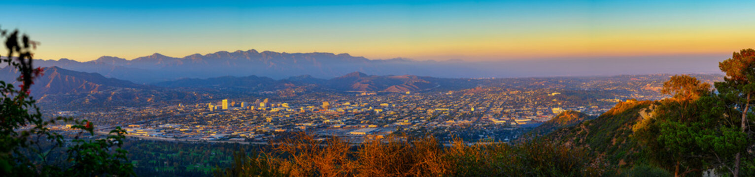 Panorama of sunset above downtown Glendale and San Gabriel Mountains in background viewed from Griffith Park near Los Angeles, California.