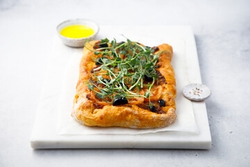 Pizza with olives and sun dried tomatoes