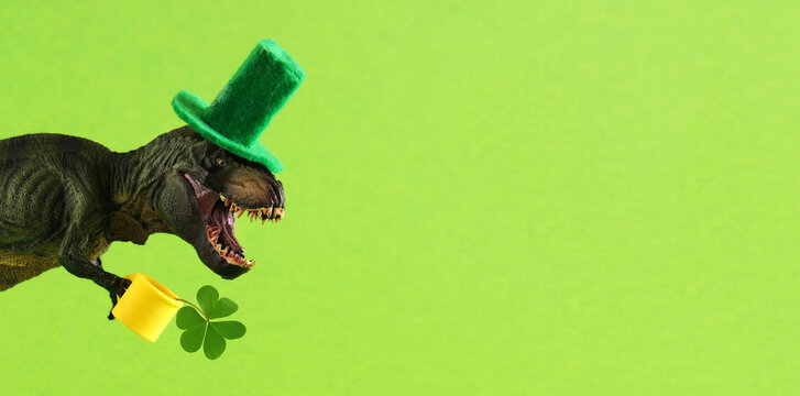 Two green dinosaurs in green hats with beer and clover leaf celebrating St. Patrick's day. Place for text.