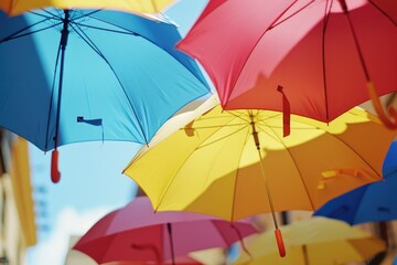 Colorful umbrellas hanging from the side of a building. Perfect for adding a vibrant touch to any urban or outdoor scene
