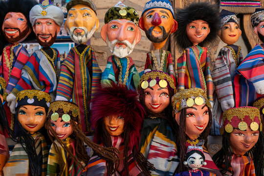 Dolls dressed in traditional uzbek costumes. Traditional souvenir puppet from painted mashed paper papier mache . Itchan Kala Xiva Ichon Qala . Khiva, Uzbekistan. Souvenir and gift concept