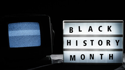 Black History month signboard and static tv