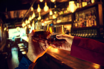 Corporate event services offering a whiskey bar for events. Male hands, businessmen clinking...