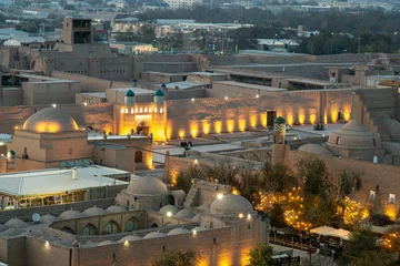 Fotobehang The ancient Zindan building and entrance gate to the fortress in the city of Khiva in Khorezm. Kohna Ark gates of the palace at night, top view from above © diy13