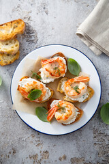 Shrimp crostini with cream cheese and herbs
