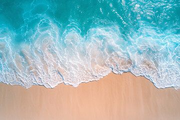 Fototapeta premium Beautiful blue waves crashing on an empty beach, aerial view, summer vacation background