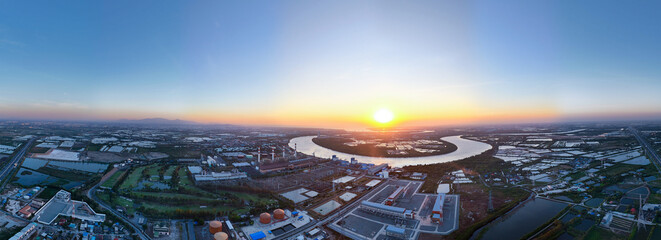 Panoramic aerial view of a power plant on a riverside drone.