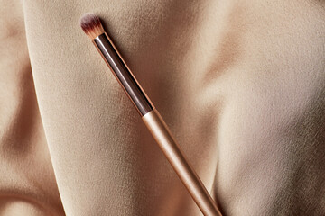 Elegant Makeup Brush on Textured Fabric