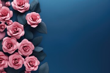 Beautiful pink roses on dark blue background. Top view with copy space