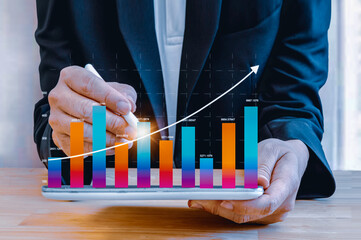 Businessman showing growing virtual holographic stock,positive indicators in 2024, businessman...