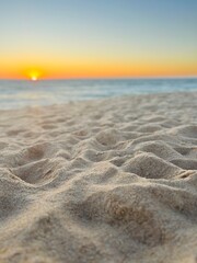 Sunset at the empty beach, tender sea sand ant sunset sun in the sea horizon 