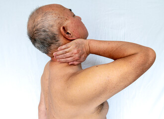 Side view of a senior man with neck pain isolated in white.