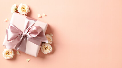 Gift box with ribbon bow and roses buds on pastel beige background. Happy Valentines day, Mothers...