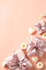 Fototapeta na wymiar Valentine's day, February 14 concept. Vertical banner with gift boxes, roses buds on beige background. Love, romance concept.
