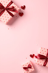 Valentine's Day gift boxes and hearts on pink background. Flat lay, top view, vertical - obrazy, fototapety, plakaty