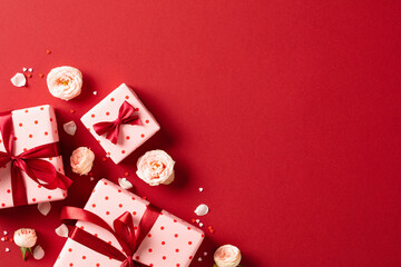 Top view photo of Valentine's day gift boxes and decorations or red background.