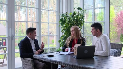 Businessmen share new house preferences to real estate agent in brokerage office. Friends find professional property manager from estate company