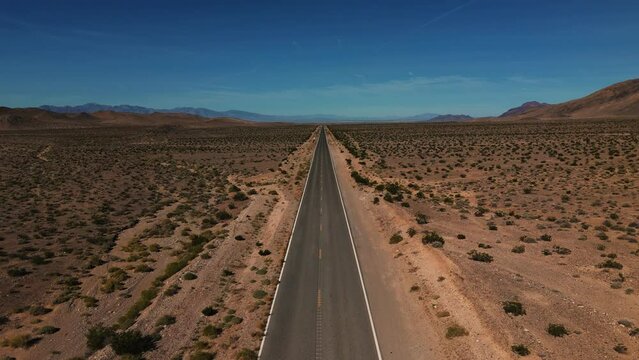 Desert highway in Nevada. Empty lonely street to nowhere. Road from above in the dry hot Wild West America landscape. Aerial drone