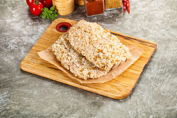 Breaded raw breaded meat schnitzel