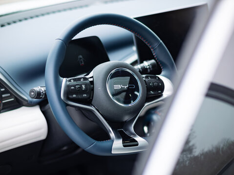 BERLIN, GERMANY - 5. January 2024: Steering wheel of the BYD Atto 3 electric car. The SUV from the Chinese manufacturer conquers the market. The cockpit material is vegan leather.