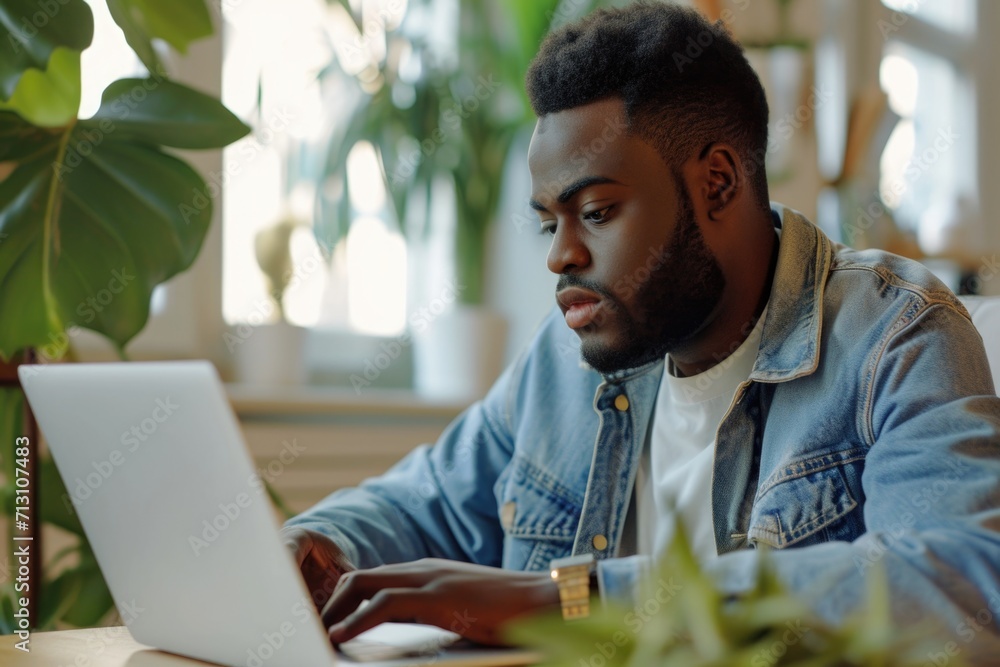Poster a man sitting in front of a laptop computer. suitable for business, technology, or remote work conce
