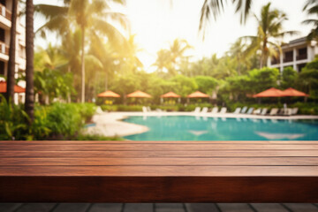 Fototapeta na wymiar Wooden table pool bokeh background, empty wood desk product display mockup with blurry tropical hotel resort abstract poolside summer travel backdrop advertising presentation. Mock up, copy space.