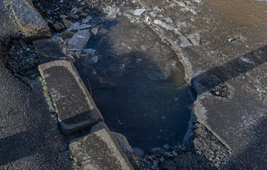 pothole full off water and ice