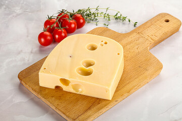 Maasdam cheese brick over board