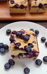 Fototapeta premium Plate of Mouthwatering Homemade Blueberry Cake Served with Fresh Blueberries