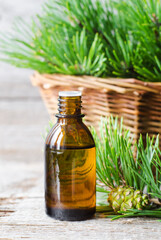 Small bottle with essential pine oil. Aromatherapy, herbal medicine, natural skin care, homemade spa and beauty treatment.
