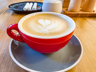 Cappuccino in a beautiful cup stands on the table.