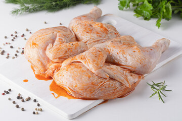 Whole chicken carcass with seasonings on white background for your meat menu or booklet design