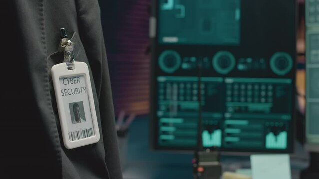 Cropped closeup of African American male cybersecurity agent wearing badge attached to pocket of his suit while at workCropped closeup of African American male cybersecurity agent wearing badge attach