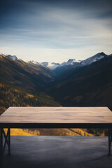 Wooden table mountains bokeh background, empty wood desk surface product display mockup with blurry nature hills landscape abstract travel backdrop advertising presentation. Mock up, copy space.