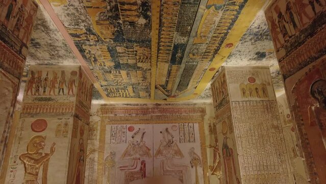 Luxor, Egypt: Hieroglyphs and murals of the double scene of Osiris decorate the interior of the tomb of Ramsses V and VI in the valley of Kings in Luxor in Egypt with a tilt down.