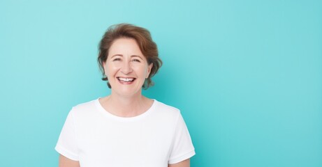 Obraz premium Joyful middle-aged woman radiating beauty with healthy skin and a bright smile