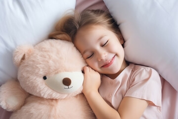 Obraz na płótnie Canvas Top view of cute little preschooler girl lying cuddling with favorite fluffy toy waking up in cozy home bed