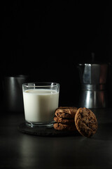 A glass with milk and chocolate cookies