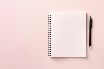 school notebook on a pink background, spiral notepad on a table