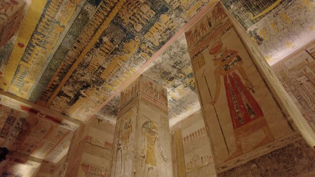 Luxor, Egypt - November 25 2023: Hieroglyphs and murals of the double scene of Osiris decorate the interior of the tomb of Ramsses V and VI in the valley of Kings in Luxor in Egypt with a tilt down.