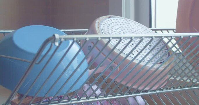 Close up of dish rack with freshly washed dishes