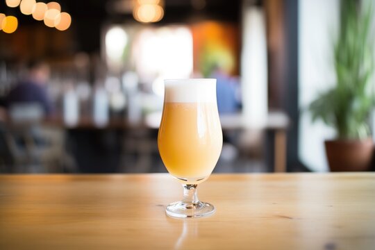 saison beer in a glass with a frothy head