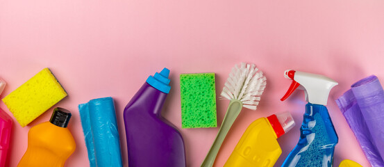 Cleaning service concept.Home cleaning product on a pink background. Bucket with household...