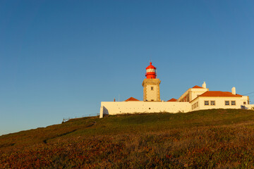 Fototapeta na wymiar Lighthouse on the cliff at Cabo da Roca or Cape Roca is westernmost cape of mainland Portugal, Sintra, Lisbon, Portugal