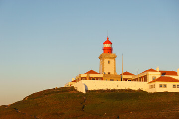 Lighthouse on the cliff at Cabo da Roca or Cape Roca is westernmost cape of mainland Portugal,...