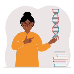 A woman holds a DNA model in his hand and there are many books nearby.