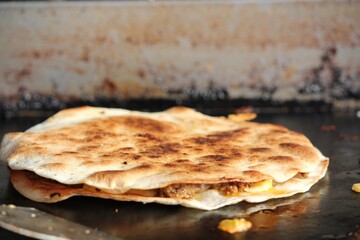 Pita bread cooking on a hot pan. Traditional oriental food.